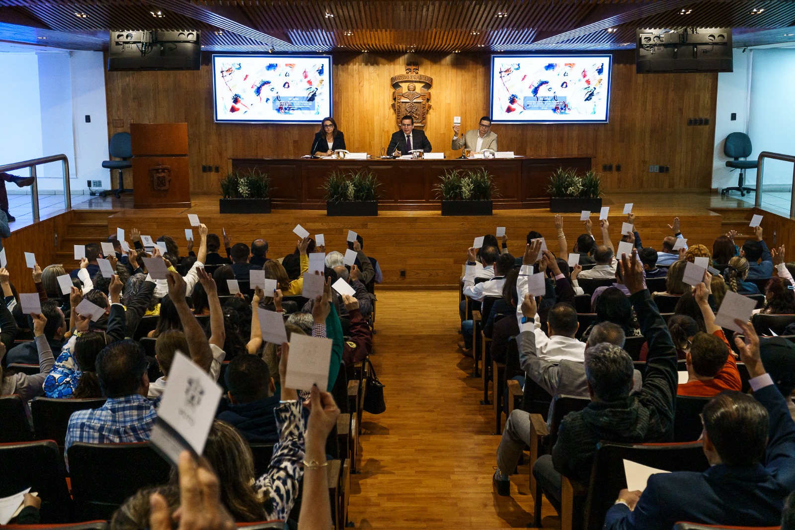 Autoridades del evento en presidium frente a asistentes en auditorio