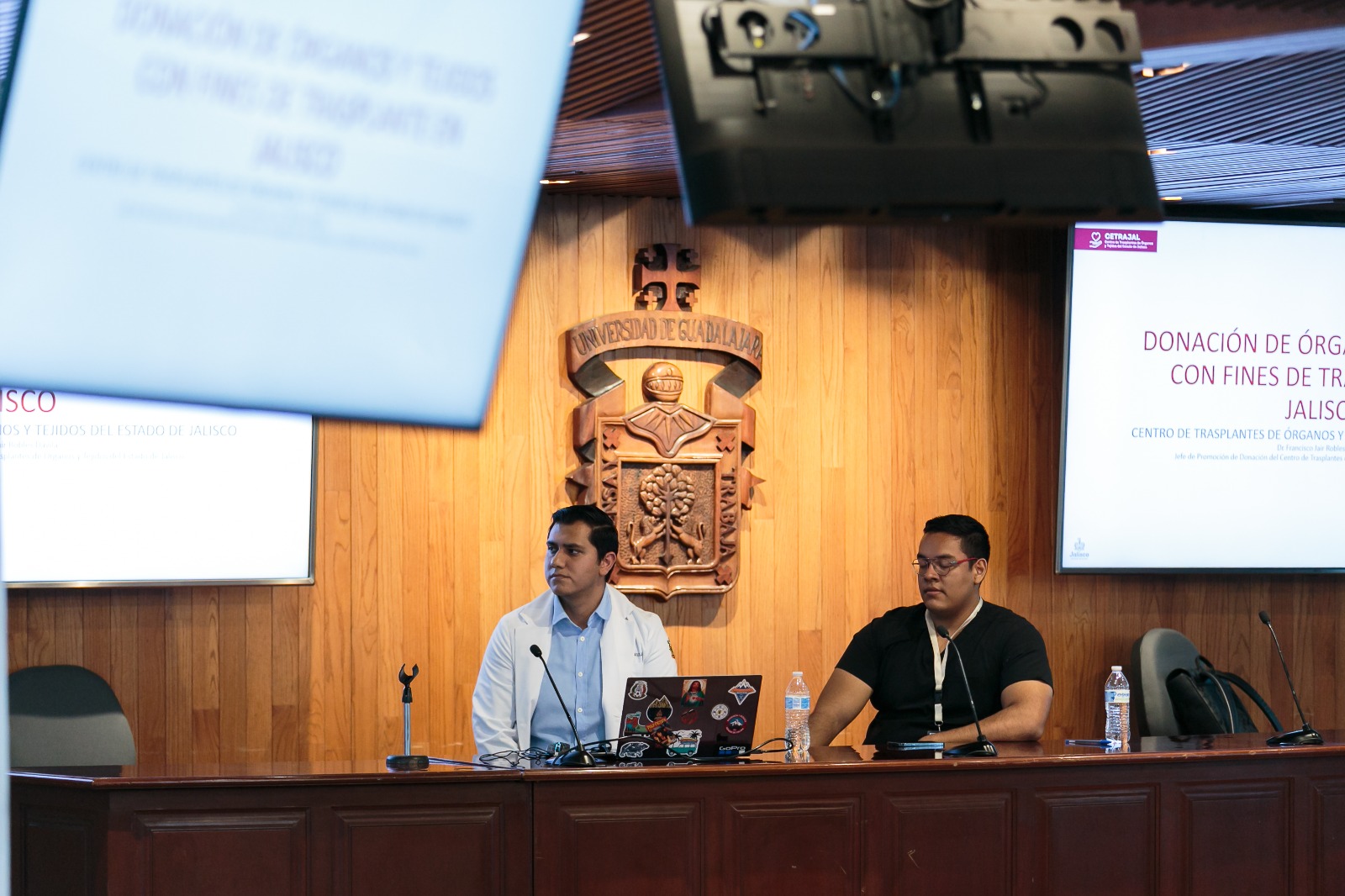 Exponentes sentados en presídium frente a asistentes