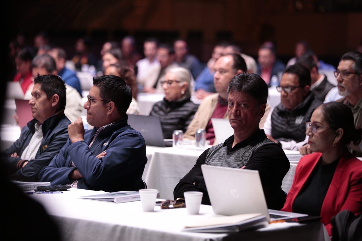 asistentes al evento sentados en auditorio