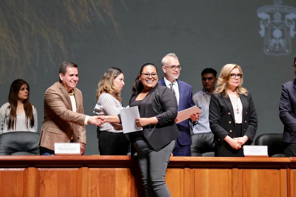 Autoridades del evento en presidium entregando documentos de nombramiento