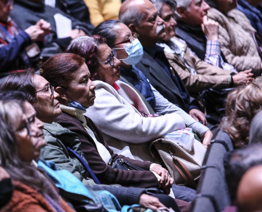 Personas asistentes al evento sentadas en auditorio