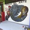 Artista junto a mural