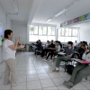 Alumnos y docente en clase presencial en aula
