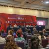 Autoridades del evento junto a asistentes en auditorio
